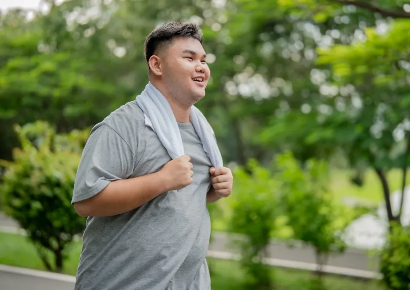 asian plus size man exercises outdoors in the gard utc