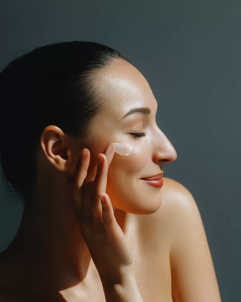 elegant woman applying facial cream for beauty rou utc