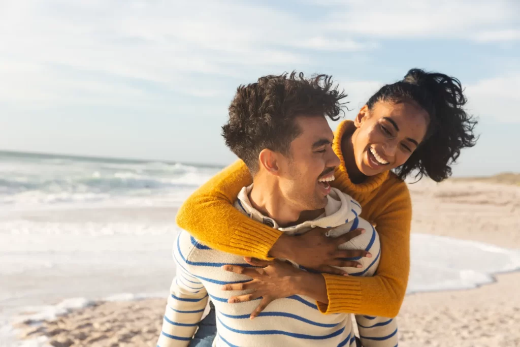 cheerful biracial man giving piggyback ride to gir utc