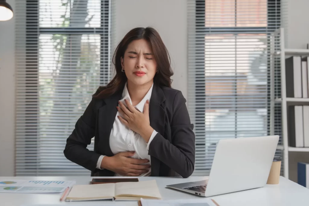 stressed businesswoman experiencing chest pain and utc