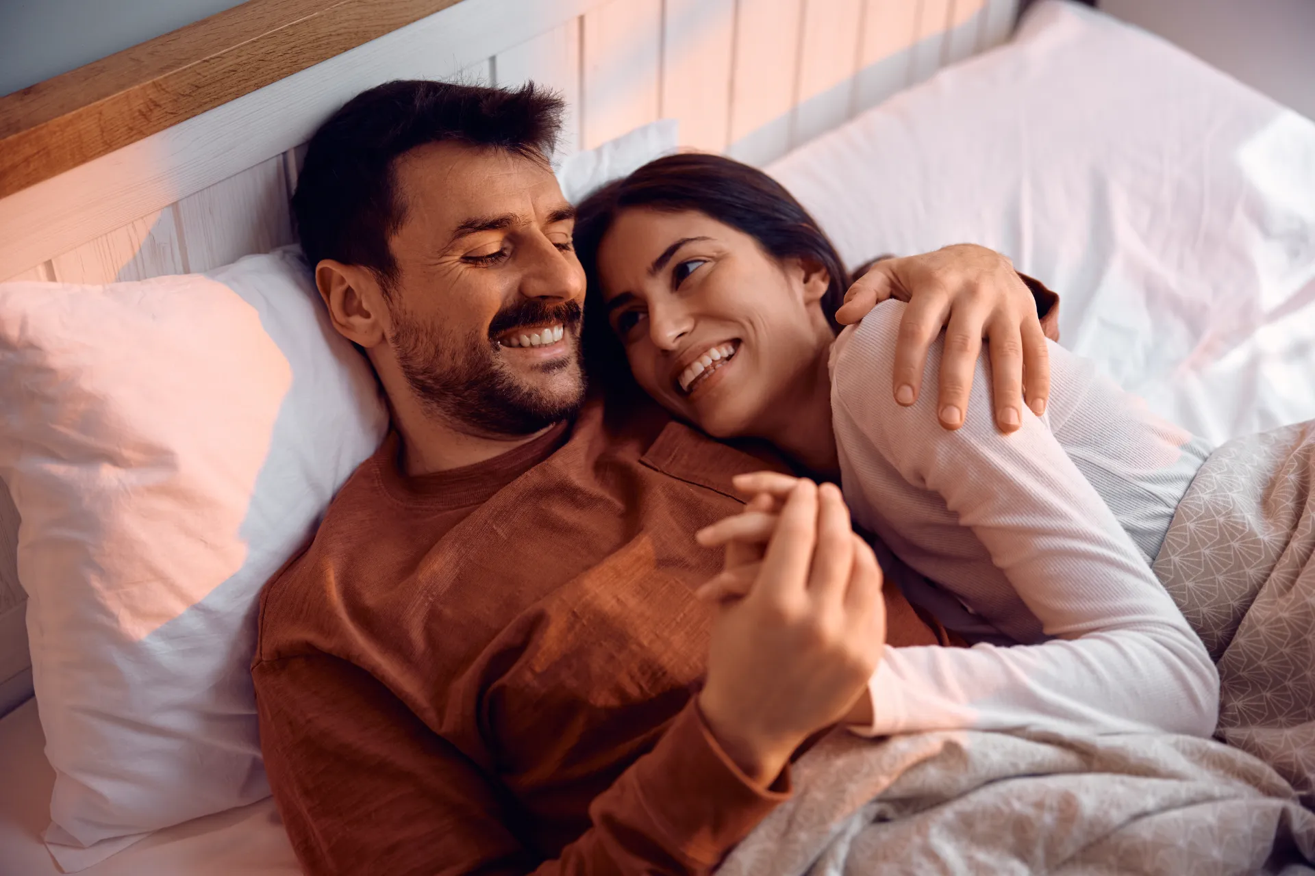 loving couple relaxing in bed together utc