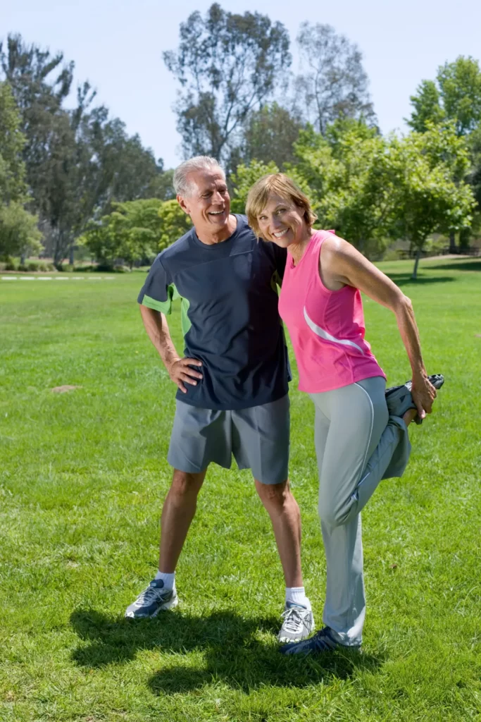 active mature couple exercise by stretching in par utc